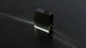 Daylight passing through a smoked glass block and separating into soft bands